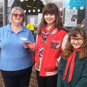 Co-op staff member Sue Shuker, with scout Lucy Cox and cub Emily Cox in April when Romsley Co-op presented £100 to Romsley Scout Group after raising the money in an Easter Raffle organised by the store.