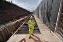 PROGRESS: Interserve project manager Nathan Wakfer next to one of the incomplete retaining walls next to junction 6