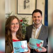 Siobhan King and Chris Passey with a copy of Millie's Socks