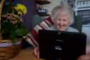 A care home resident video calling with family during the coronavirus lockdown