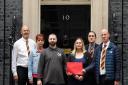 Relatives of victims of the NHS infected blood scandal (left-right) Temple Jones, Janine Jones, Jason Evans, Gemma Holding, Tim Wratten and Chris Smith hand in a letter to 10 Downing Street.