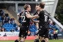 Kyle Dempsey celebrates his goal with Aaron Collins and Dion Charles