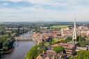 Taken from the tower of Worcester Cathedral overlooking the River Severn (northwards). Main road bridge and railway viaduct span the river. St Andrew's Spire (AKA the Glover's Needle) is seen on the RHS of the image. Worcester Racecourse in seen i