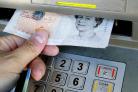 Vulnerable woman robbed at cashpoint by thugs who emptied her account