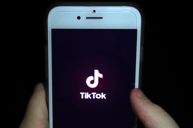 TikTok app open on a phone. Credit: PA