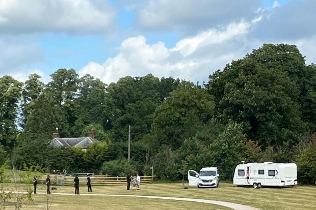 Enforcement officers approaching the travellers at Cherry Tree Park in Claines.