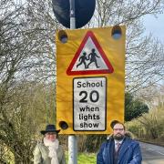 Rachel Maclean and Cllr Mike Rouse by a speed sign in Hanbury.