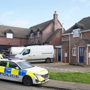 MURDERL Police at the scene in The Row in Sutton, near Ely, Cambridgeshire, where police found the body of a 57-year-old man who had died from gunshot wounds on Wednesday evening.