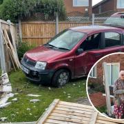 ANGRY: Kate Hooper and her son John by the damaged fence in Droitwich.