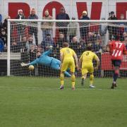 Luke Rowe tucks home the late penalty to seal Bromsgrove Sporting's 3-0 win over leaders Needham Market